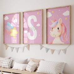 three children's wall hangings in a child's room with pink and white decor