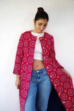 "This is a vintage red quilted puffy robe or duster coat featuring a charming white and blue floral print in a circular pattern. It is fully lined in blue, has a ruffle edge on the sleeves and at the bottom of the coat, and has an empire waist design. The coat is adorned with white buttons along its length and has a single outer pocket on the right side. The original tag is intact, reading \"GIGETTE,\" and it is union-made with the ILGWU label still in place. aside from minor signs of wear, good vintage condition, clean, and ready to wear. ** Model is 5'7\" and size S for reference  Approximate size: S - please refer to the measurements. M E A S U R E M E N T S -were taken with garments laying flat, please double where necessary. ------------------------♥-------- Bust: 18.5\"-47cm  Empire Red Long Cotton Outerwear, Long Red Cotton Outerwear, Red Long Outerwear With Buttons, Long Red Outerwear With Buttons, Retro Red Outerwear For Spring, Retro Red Spring Outerwear, Cotton House, House Coat, Red Quilts