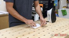 a man is working on a project in his home office with wood workbench