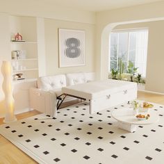 a living room with white furniture and black and white rugs on the hardwood floor