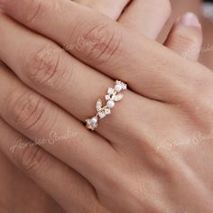 a woman's hand with a ring on it and two diamonds in the middle