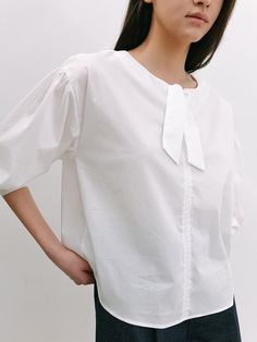 Editor's NotesThis blouse is made of cotton, nylon, and span. It features a dropped shoulder and shirring detail, and a feminine mood. Wear this item with short pants and sandals for a perfect daily look. - Classic design long-sleeve blouse- Relaxed fit and a comfortable fit - Semi-cropped length and volume sleeve- Ribbon detail on the neckline  Measurements(in.)One size (XS-M)- Shoulder: 20.07 in. - Chest: 21.65 in. - Sleeve Length: 20.86 in. - Total Length: 23.62 in. Model Info: Mahina Height 5' 67, Wearing S size  Composition & Care- Shell: 67% Cotton 30% Nylon 3% Span  - Dry Clean Recommended Designer- by LAMINEZ Cotton Puff Sleeve Blouse With Tie Sleeves, Cotton Blouse With Tie Sleeves And Puff Sleeve, Cotton Blouse With Tie Sleeves For Daywear, Spring Daywear Blouse With Tie Sleeves, Cotton Blouse With Tie Sleeves And Relaxed Fit, Casual Cotton Blouse With Tie Sleeves, Tie Sleeve Tops For Summer Workwear, Summer Workwear Tops With Tie Sleeves, Summer Tops With Tie Sleeves And Relaxed Fit