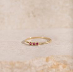 A stacking ring for women with ruby in 14K solid yellow gold. A dainty minimalist 3 stone ring for women with natural gemstones and a great birthday gift as ruby is the July birthstone. 100% handcrafted with love! * Material: 14K solid gold, 14K white gold * Gemstones: Ruby, round cut * Gemstones' Weight: 0.06 ct HOW TO ORDER * Choose from the drop-down menus the available options (Ring size, Material) and leave us a note for any special requirements. PRODUCTION TIME - SHIPPING POLICIES * Please Stackable 14k Gold Ruby Ring For Promise, 14k Gold Stackable Ruby Promise Ring, Promise Stackable 14k Gold Ruby Ring, 14k Gold Stackable Ruby Ring Fine Jewelry, 14k Gold Fine Jewelry Stackable Ruby Ring, 14k Gold Stackable Ruby Ring In Fine Jewelry Style, Stackable Ruby Ring In 14k Gold With Round Band, Dainty Stackable 14k Gold Ruby Ring, Dainty 14k Gold Stackable Ruby Ring