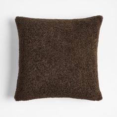 a brown pillow on a white background