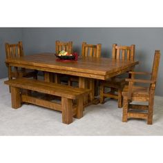 a wooden table and chairs with a bowl of fruit on top