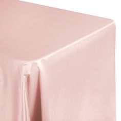 a plain pink tablecloth draped over it