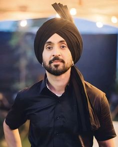 a man wearing a turban and black shirt