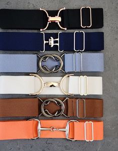 six belts with metal buckles on them are lined up in different colors and sizes