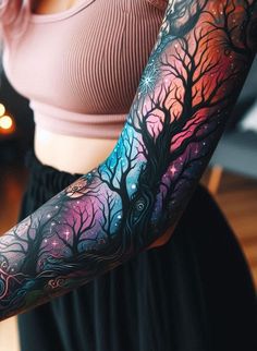 a woman's arm with trees and stars painted on it