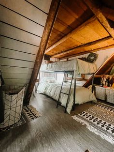 an attic bedroom with bunk beds and rugs