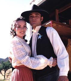 a man and woman dressed in western clothing