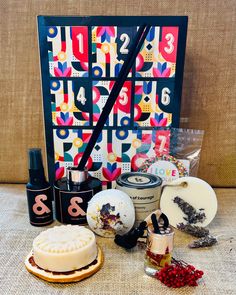 the contents of a bath and body care gift set sitting on a table in front of a calendar