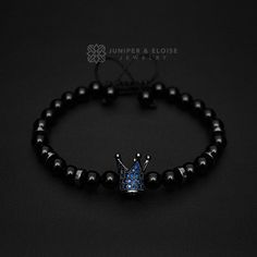 "top jewelry gifts for men and women, gifts for boyfriend, unique gifts ideasHandcrafted bracelet made with 6mm Onyx beads, featuring black crown with Sapphire blue Zircon stones and hematite spacer beads. It's adjustable, utilizing a sliding knot made with macrame cord and is easy to put on and take off by yourself. Please choose one of the 2 size options (For Men or Women) from drop down menu. Men`s Size : 7\"- 8.5\" (18 cm -21 cm) Women`s Size: 6\"-7.5\" (16 cm -19 cm) All of our jewelry come Adjustable Black Jewelry For Father's Day, Black Crystal Gemstone Bracelet Gift, Black Crystal Gemstone Bracelet As A Gift, Black Gemstone Crystal Bracelet Gift, Black Bangle Bracelet As A Gift, Gift Black Crystal Bracelet, Black Spiritual Jewelry For Father's Day, Spiritual Black Jewelry For Father's Day, Black Crystal Bracelet With Natural Stones For Gift