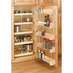 an image of a kitchen cabinet with spice racks on the door and shelves in the bottom