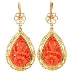 Presenting vintage Pear-Shaped Coral Dangle Drop Earrings, each piece meticulously carved from a single piece of natural coral. These exquisite retro earrings depict a delicate scene of a flower with a resting butterfly, beautifully encased in a textured 18K yellow gold frame. Enhanced with fine filigree borders, the robust bezel setting ensures each earring hangs gracefully. Featuring elegant gold flower lever-back closures, these tear-drop dangle earrings offer both comfort and security, allowing them to sway gently with every movement. Perfect for those who appreciate the art of vintage jewelry, these earrings add a touch of nature-inspired beauty to any look. The earrings are 2.1" long  Marked 18K  Excellent Condition Accompanied by gemologist Appraisal Document Luxury Carved Earrings For Formal Occasions, Carved Yellow Gold Earrings For Formal Occasions, Elegant Carved Yellow Gold Earrings, Formal Carved Yellow Gold Earrings, Elegant Coral Earrings For Formal Occasion, Formal Carved Gold Earrings, Formal Gold Carved Earrings, Elegant Carved Orange Jewelry, Elegant Orange Carved Jewelry