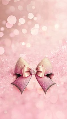 two pink bows with glitters and sparkle in the background for a greeting card or wallpaper