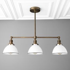 three lights hanging from the ceiling in a room