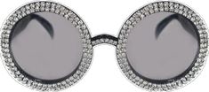 a pair of sunglasses with round frames and crystals