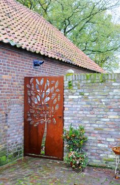 a metal door with a tree on it