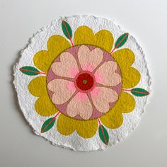 a paper circle with a flower painted on it