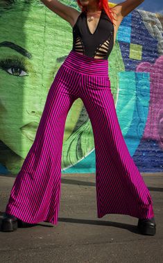 The Pink & Black Stripe Big Bells are your go-to stylish everyday pant. Dress these flattering pants up or down- truly perfect for almost any occasion. Design Features: High waistband hits comfortably at your true waist Waistband can be rolled down to expose belly Perfectly hugs hips Pant leg flares into large bells Fantastic garment to dress up and down. Incredibly vibrant print. Made in San Francisco, CA, USA Fabric Features: Radical vertical Pink and Black stripe. Moisture Wik Polyester/Spand High Waist Yoga Pants With 4-way Stretch For Spring, Summer Versatile Elastic Bottoms, Versatile Elastic Summer Bottoms, Versatile Elastic Bottoms For Summer, Trendy Stretch Harem Pants With Elastic Waistband, Spring Yoga Stretch Wide Leg Pants, Non-stretch Hip-length Bottoms For Night Out, Versatile Elastic Bottoms For Spring, Versatile Fitted Wide Leg Pants For Summer