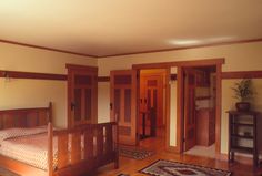 an empty bedroom with wooden furniture and wood flooring is pictured in this image from the front door