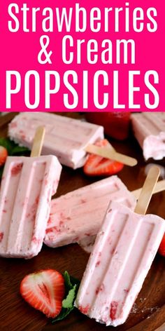 strawberries and cream popsicles on a wooden plate with text overlay that reads strawberry ice cream popsicles