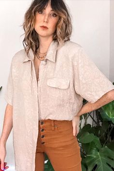 Beautiful pure silk short sleeve button up is the ultimate chic and polished minimalist wardrobe staple. Neutral light beige silk with a subtle sheen & has a textured ornate floral and print that covers the entire top. Neutral silk tops like this are perfect for styling casually year round or as a go to professional wardrobe piece. Looks great tied up, tucked in or half tucked for an effortless artist chic outfit #silkbuttondown #buttondownshirtoutfit #vintageoutfit #rofessional Neutral Silk, 80s Era, Silk Tops, Beige Silk, Professional Wardrobe, Minimalist Wardrobe, Chic Outfit, Silk Shorts