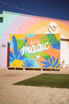 a large mural on the side of a building that says bed like magic in front of it