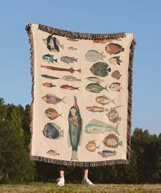 a person standing in front of a blanket with fish on it