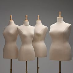 three white mannequins are standing next to each other