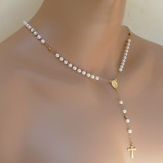 Elevate your spiritual style with our stunning Rosary Necklace with Gold Chain and Elegant Pearl Beads. Made with the utmost care and attention to detail, this unique piece of religious jewelry is the perfect way to showcase your faith in style. Crafted with beautiful artificial pearl beads and a stunning gold plated chain, this rosary . It's comfortable to wear and perfect for layering with your other favorite necklaces. Whether you're dressing up for a special occasion or looking for an everyd Pearl Necklaces With 8mm Beads For Gifts, Spiritual Single Strand Pearl Necklaces, Pearl Necklace With 8mm Beads For Gifts, Spiritual Beaded Jewelry For Anniversary, Spiritual Gold Bridal Necklace With Round Beads, Spiritual Pearl Drop Necklace With Round Beads, Elegant Beaded Rosary For Jewelry Making, Spiritual Pearl Chain Jewelry With Round Beads, Spiritual Cross-shaped Pearl Chain Jewelry