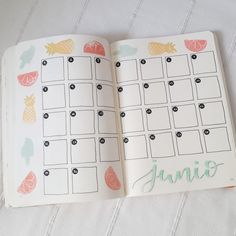 an open planner book with the word june written on it