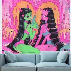 two women sitting on a couch in front of a wall with pink and green graffiti