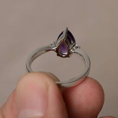 This is a gorgeous handmade creation. Its beauty is its simplicity & Elegance. The 6*9 mm pear shape faceted natural amethyst is crafted in solid sterling silver and with rhodium plated. All item is sent in a beautiful gift box If you have any idea of design your ring,pls contact me directly. You can realize more lovely stuff clicking the link https://www.etsy.com/shop/knightjewelry?refshopsection_shophome_leftnav Please leave the correct address and you phone number for delivering successfu Fine Jewelry Teardrop Solitaire Ring, Fine Jewelry Teardrop Crystal Ring For Anniversary, Teardrop Crystal Ring For Anniversary, Pear-shaped Birthstone Promise Ring, Fine Jewelry Teardrop Purple Ring, Teardrop Prong Setting Promise Ring, Teardrop Amethyst Ring For Anniversary, Teardrop Amethyst Ring For Wedding, Fine Jewelry Purple Teardrop Ring