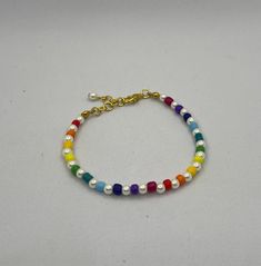 Colourful and stylish this rainbow pearl beaded bracelet is the perfect accessory to match the rainbow pearl beaded necklace. Made with seed beads and faux pearls. Length 6 inches and 1 inch extension chain. Trendy Rainbow Jewelry For Pride, Adjustable Multicolor Pearl Bracelet, Adjustable Multicolor Pearl Beaded Bracelet, Rainbow Pearl Charm Jewelry, Rainbow Pearl Jewelry With Pearl Charm, Multicolor Pearl Beaded Bracelets, Trendy Pearl Beaded Bracelets With Colorful Beads, Adjustable Multicolor Pearl Chain Jewelry, Rainbow Pearl Jewelry With Colorful Beads