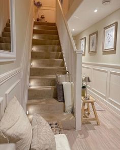 the stairs in this home are lined with pillows and throw pillows, along with pictures on the wall