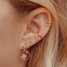 an ear with three different types of piercings on it's side and the top half