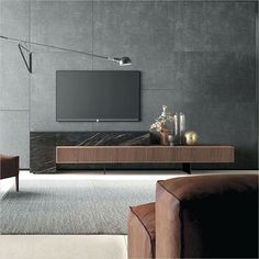 a modern living room with grey walls and furniture