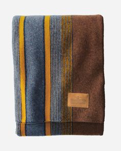 a blanket with yellow and blue stripes on it