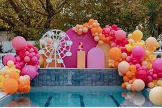 an outdoor pool decorated with balloons and streamers