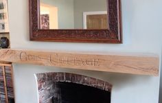 a fireplace with a mirror above it that says go cottage on the mantle next to a brick fire place