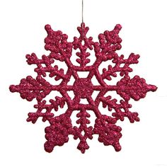 a pink snowflake ornament hanging from a string on a white background