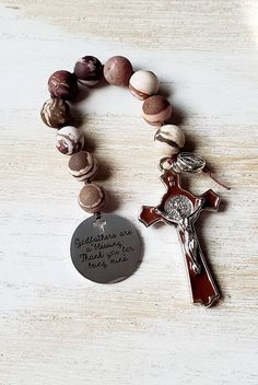 "This mini catholic rosary is the perfect gift for a godfather fro their godchild.  This handmade rosary is made using 10mm zebra jasper gemstone beads. The beads are hand knotted using nylon thread. The charm is stainless steel with a unique cross cutout, the crucifix is finely detailed, silver tone and enamel. \"Godfathers are a blessing, thank you for being mine\"" Godfather Proposal, Cross Cutout, Handmade Rosary, Zebra Jasper, Catholic Rosary, Rosary Catholic, Rosary Beads, Proposal Gifts, Baptism Gifts