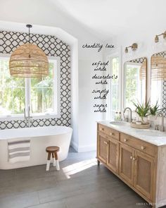 a bathroom with a tub, sink and large mirror in it's center area