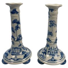 two blue and white vases sitting next to each other