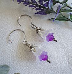 These little beauties feature a gradual stack of colors, from frosted white to violet purple. All topped with layers of silver flowery accents.   These earrings dangle approximately 1" from hypoallergenic Stainless Steel Half Hoops.  If you would prefer standard french earwire or leverbacks, please let me know!  Available in more color combinations: www.etsy.com/shop/lanzacreations/?etsrc=sdt&search_query=ombre+flower Handmade Purple Flower Earrings, Hypoallergenic Purple Flower Jewelry, Delicate Purple Flower Earrings, Purple Dangle Flower Earrings, Purple Flower-shaped Earrings, Spring Flower-shaped Purple Earrings, White Silver, Diy Earrings, Flower Earrings