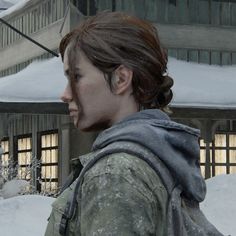 the last of us's characters are walking through the snow in front of a building