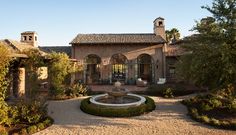 an outdoor courtyard with a fountain in the middle