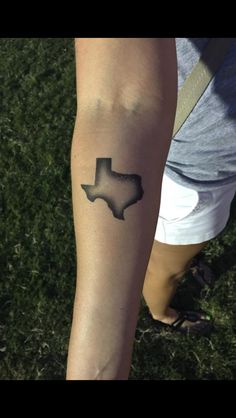 a person's arm with a tattoo on it that has the shape of texas